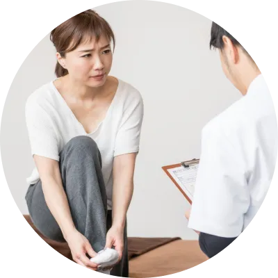 女性が足を痛めて診断をうけている写真